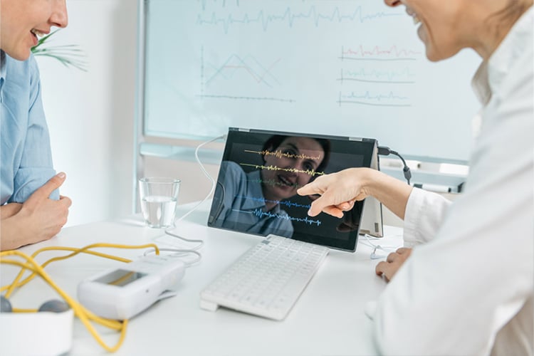 A medical device sales rep discussing the features of a medical device with a customer